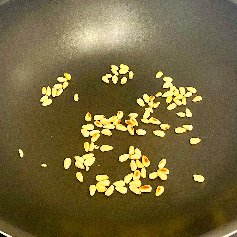 Pre-heat the frying pan and roast pine nuts until slightly brown.