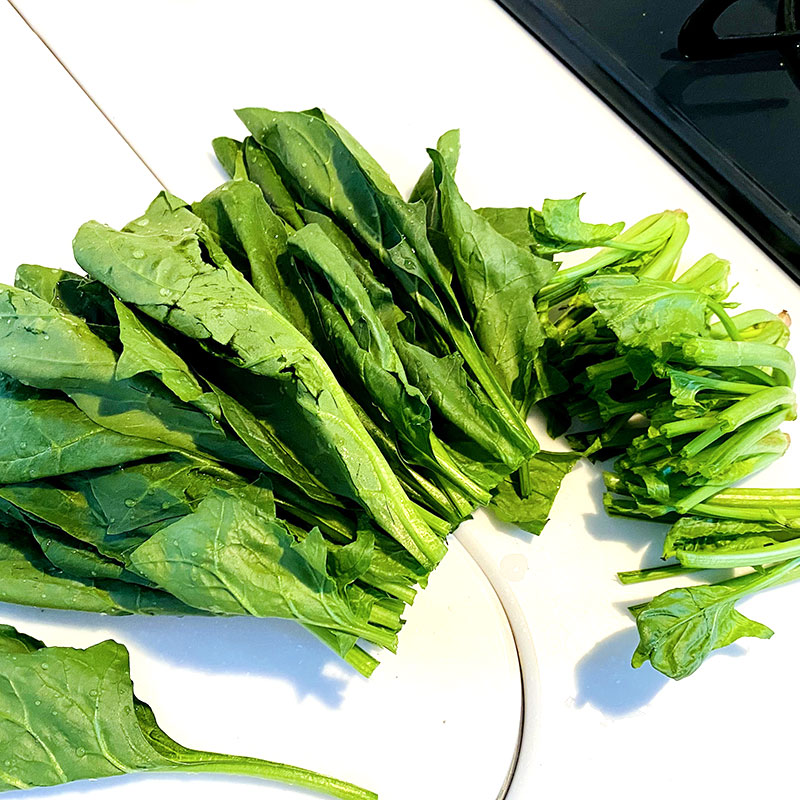 Wash and dry spinach. Cut off harder parts and stir fry over a small heat.