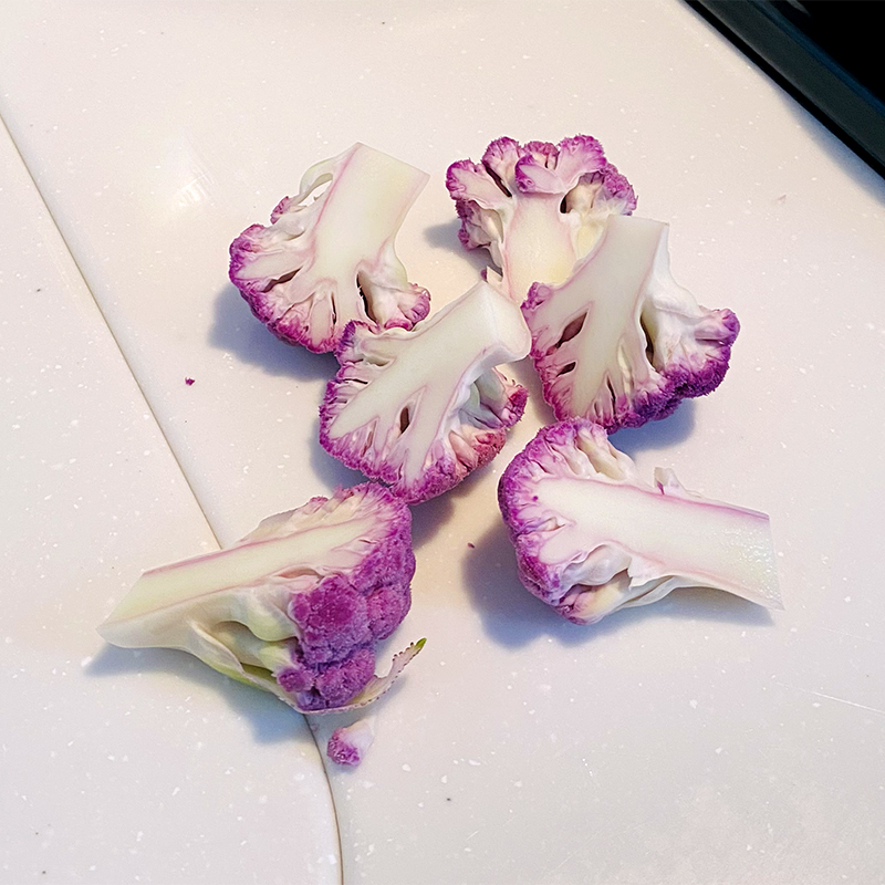 Cut cauliflower into florets and halve them.