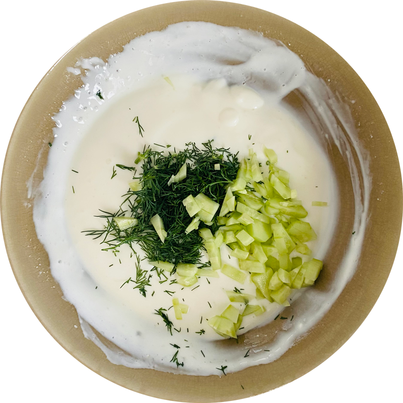 In a bowl whisk the soy yoghurt with lemon juice. Then add finely chopped dill and diced cucumber. Add pepper to taste.
